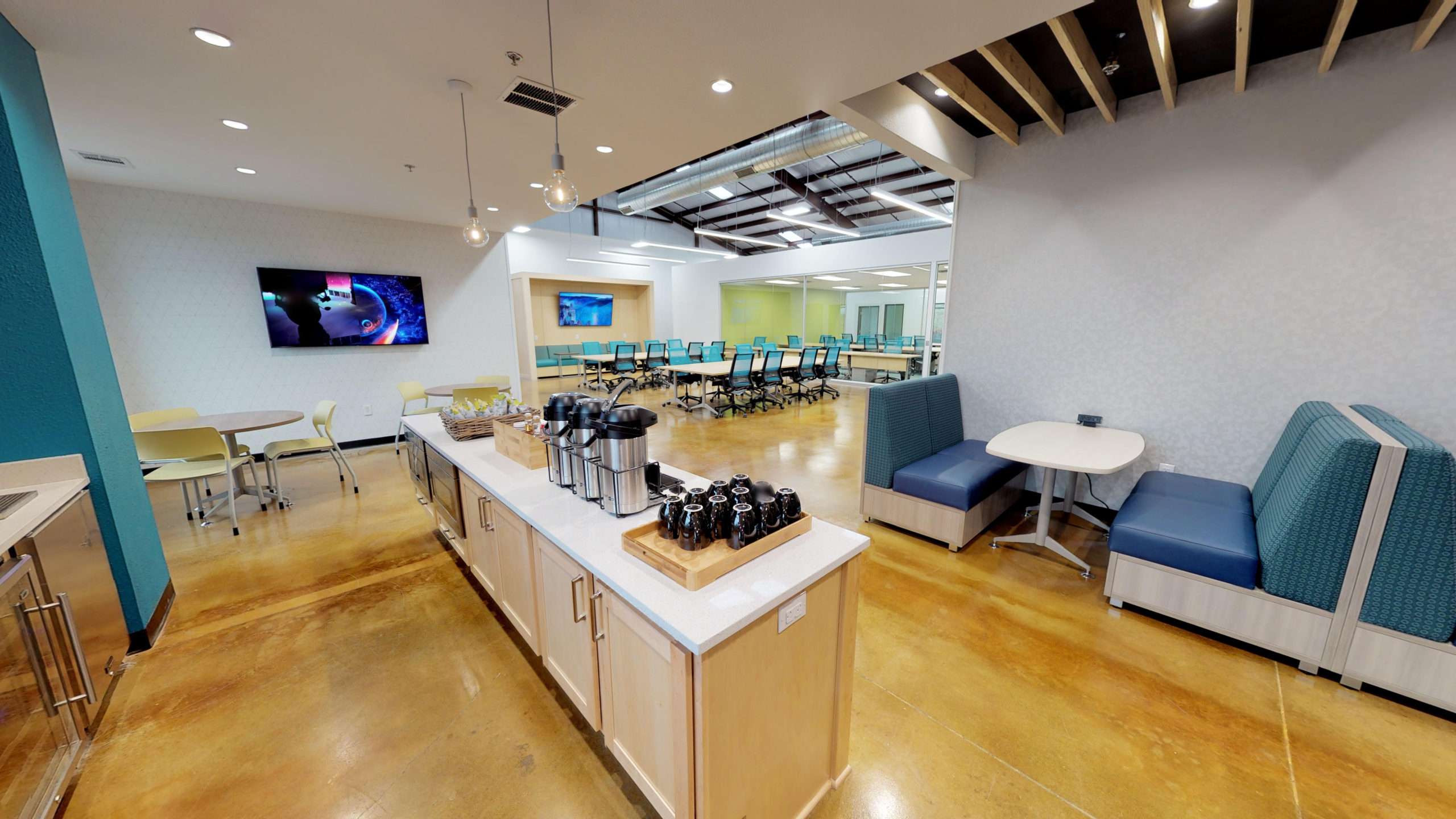 Innovation WorkSpaces in Cedar Park with coffee bar, teal accent walls, booth seating, and open workspace